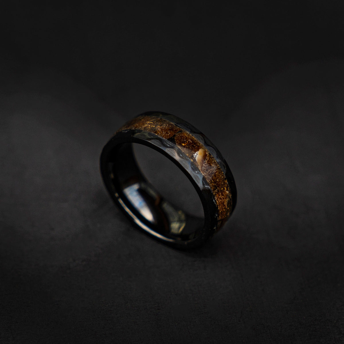 Velociraptor fragments in a black ceramic faceted hammered band, engagement ring, mens ring, handmade wedding band, mens wedding band - Decazi