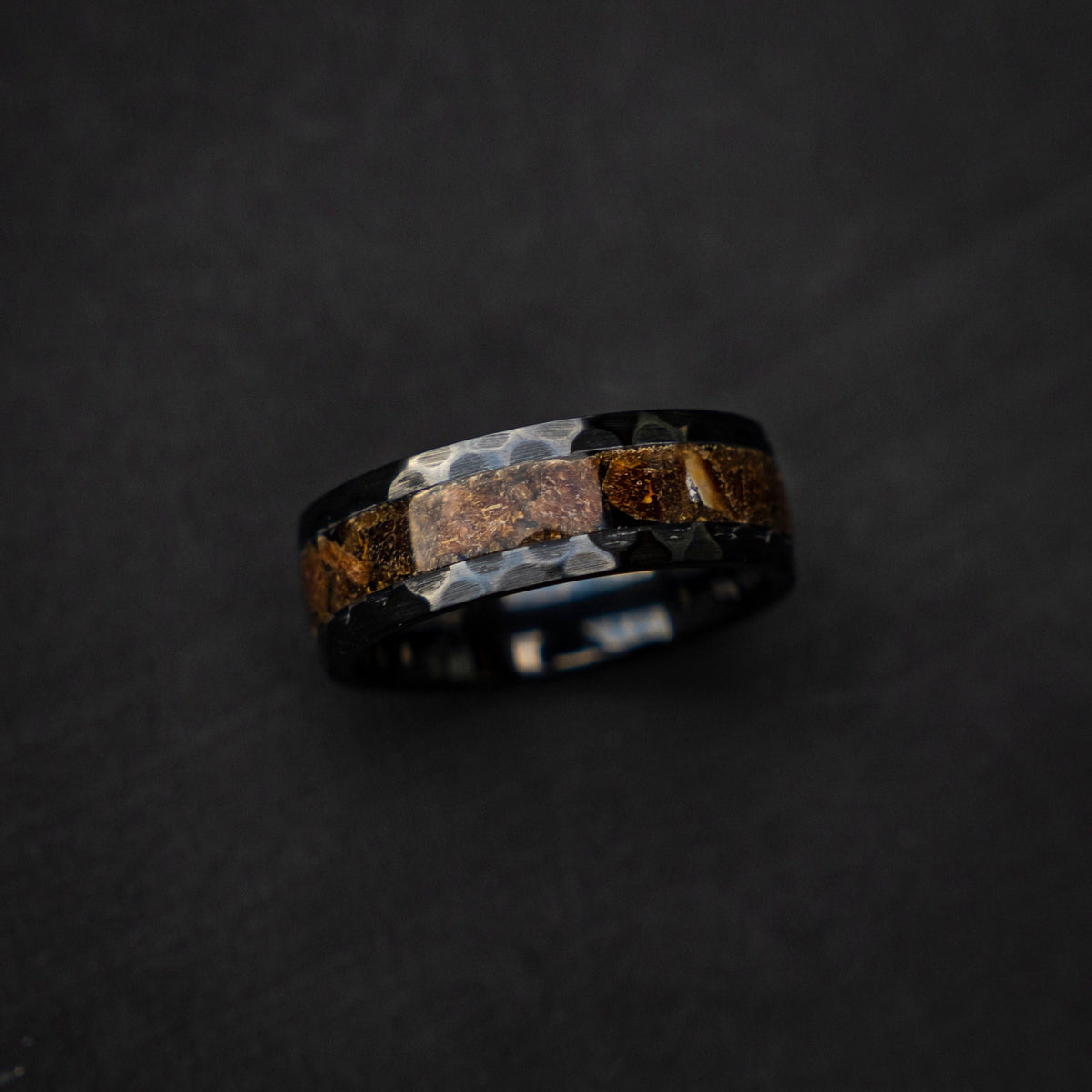 Velociraptor fragments in a black ceramic faceted hammered band, engagement ring, mens ring, handmade wedding band, mens wedding band - Decazi