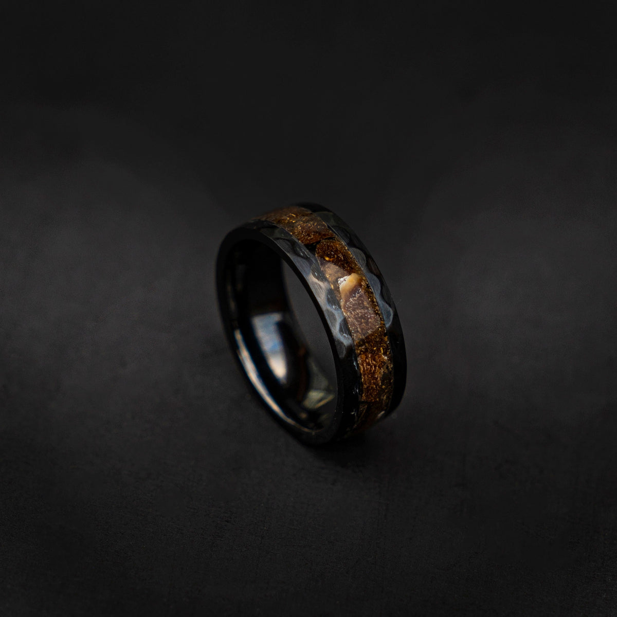 Velociraptor fragments in a black ceramic faceted hammered band, engagement ring, mens ring, handmade wedding band, mens wedding band - Decazi