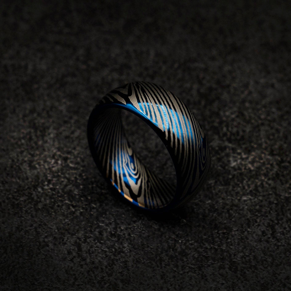 Blue tungsten ring with Damascus pattern