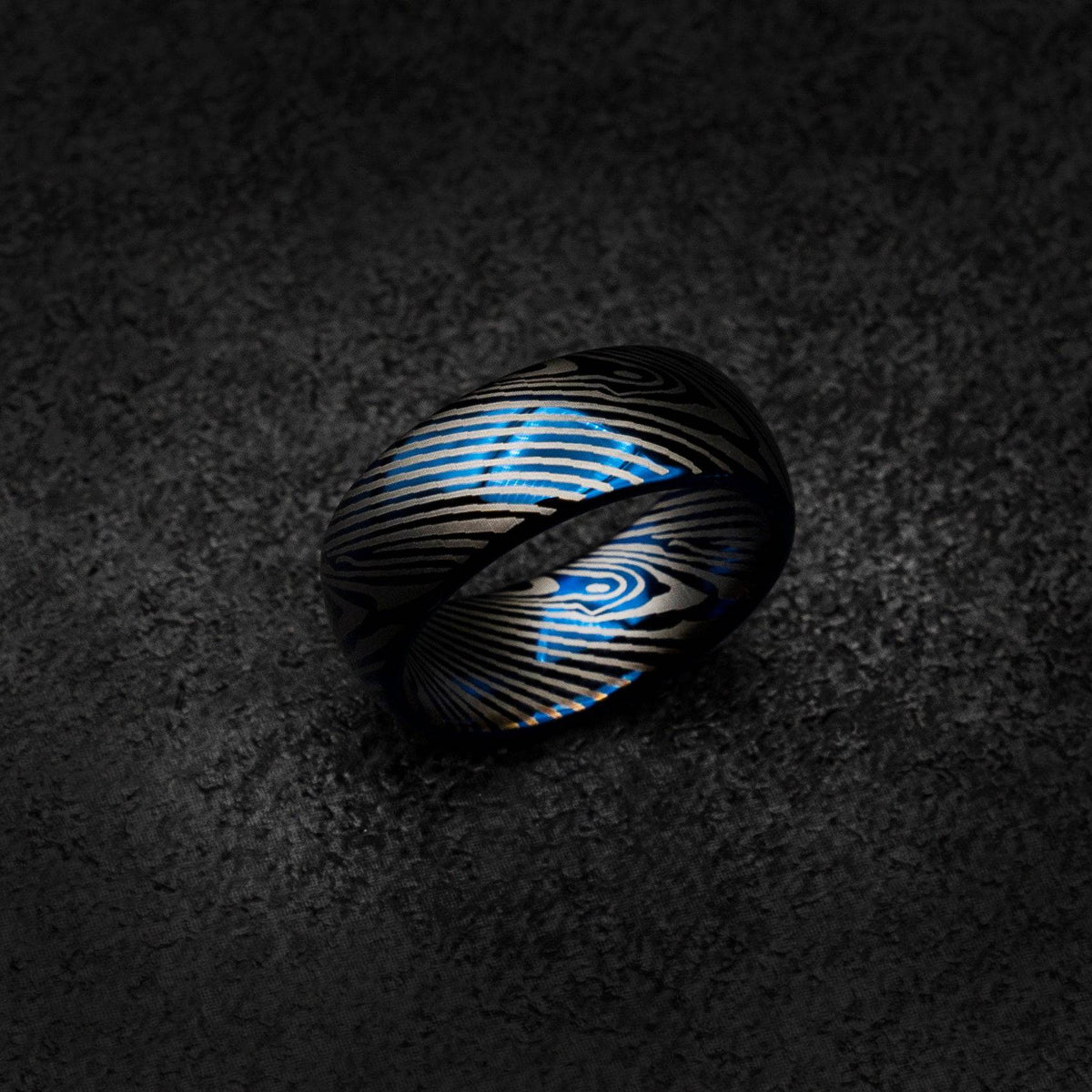 Blue tungsten ring with Damascus pattern