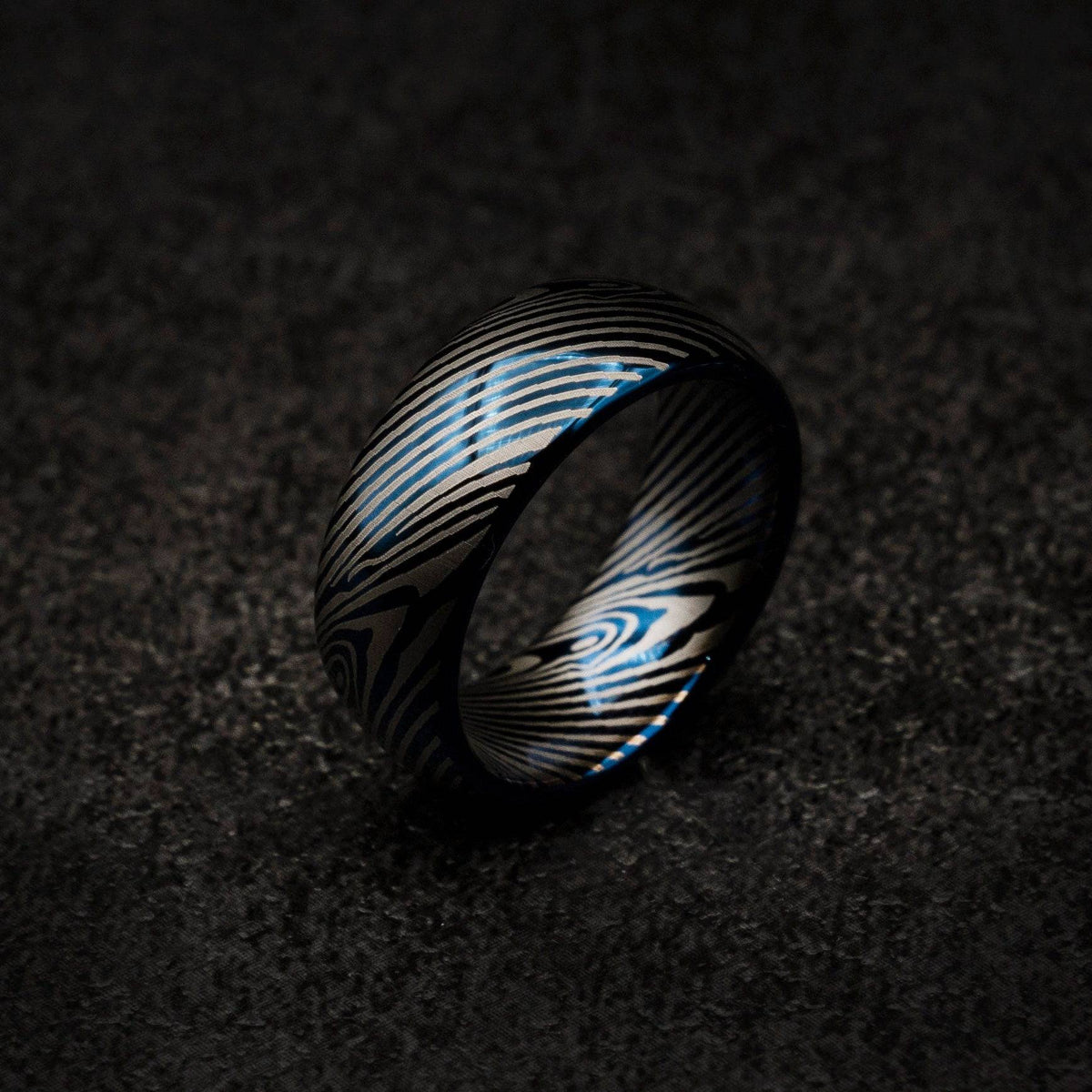 Blue tungsten ring with Damascus pattern