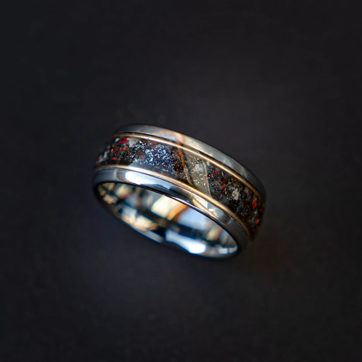 Tungsten ring filled with meteorite dust, red opal and 18k gold
