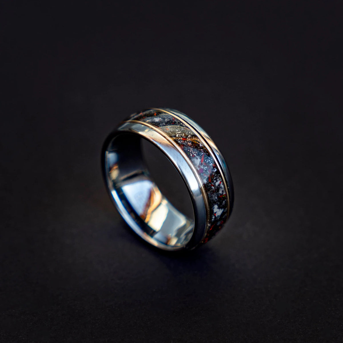 Tungsten ring filled with meteorite dust, red opal and 18k gold