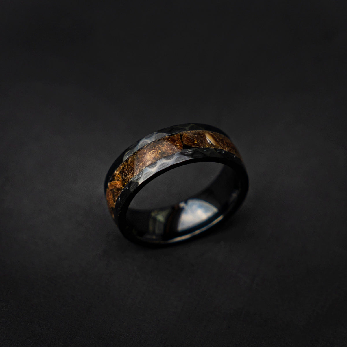 Velociraptor fragments in a black ceramic faceted hammered band,  engagement ring, mens ring, handmade wedding band, mens wedding band - Decazi
